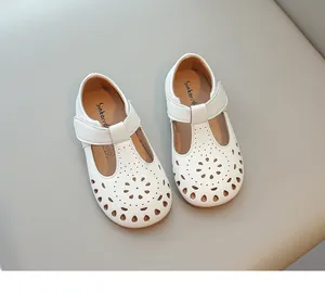 Top view of white girls' princess shoes featuring an elegant floral hollow-out design