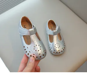 Detail view of silver hollow-out girl's Mary Jane princess shoes with soft soles for spring