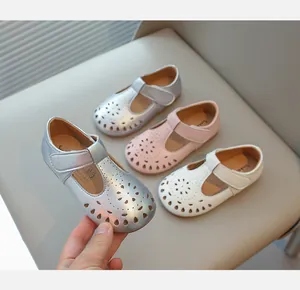 Detailed close-up of stylish hollowed-out girls' Mary Jane shoes in silver, pink and white