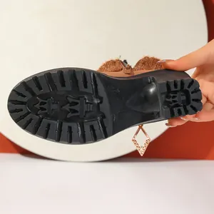Detailed view of the anti-slip lug sole on winter chunky heel ankle boots.