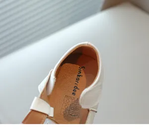 Close-up of the soft leather insole and brand logo in white girls princess shoes