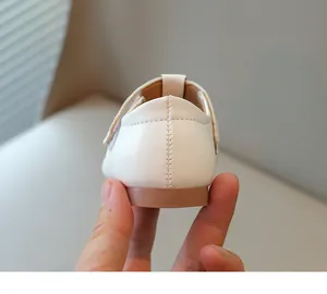 Close-up of high-quality stitching on white soft-soled princess shoes for girls