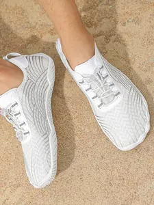 Lightweight white quick-dry water shoes for surfing and beach sports on sandy terrain