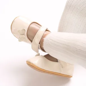 Close-up detail of beige baby girl Mary Jane shoes featuring a glittery butterfly bow decoration