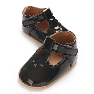 Black patent leather baby Mary Jane shoes with scalloped edges and sweet floral cutouts