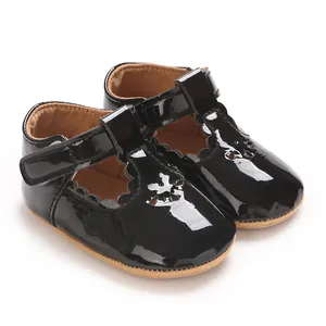 Detailed view of black patent leather baby Mary Jane shoes with hook-and-loop straps