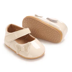 Close-up view of beige baby girl princess shoes with glitter butterfly bow detail