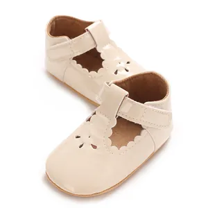 Detailed view of beige baby princess shoes with delicate laser-cut flower patterns.