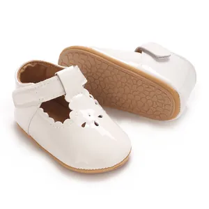 Detailed view of white baby girl princess shoes featuring non-slip soles and T-straps