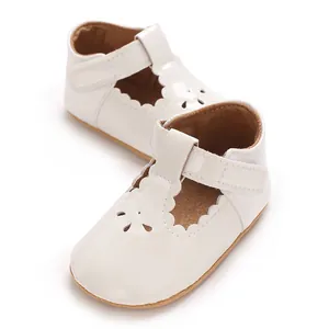 Elegant white patent leather baby princess shoes with scalloped edges and velcro strap detail