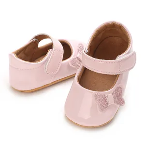 Detailed view of pink shiny baby girl princess shoes with glitter butterfly detail