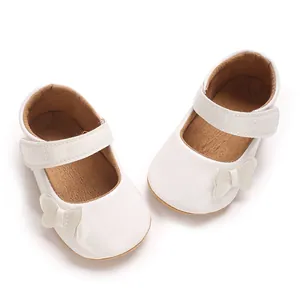 Detailed view of white baby princess shoes featuring a delicate fabric butterfly bow.