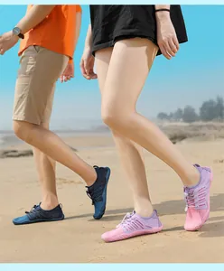 Detailed view of quick-dry water shoes for men and women on a sandy beach setting