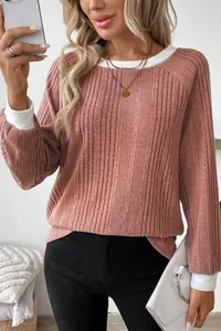 Detailed view of dusty pink ribbed knit sweater with white contrast collar and cuffs