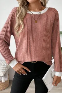 Detail shot of dusty pink ribbed knit sweater featuring white contrasting cuffs and collar