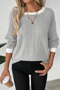 Close-up of a casual gray ribbed long sleeve sweater with white trim accents