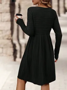 Detailed back view showing the ribbed-knit texture of a long-sleeved black casual dress.