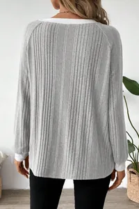 Detailed back view of a cozy grey ribbed long-sleeved sweater featuring stylish white trim
