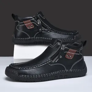 Detail view of men's black leather casual short boots with side zipper and stitching