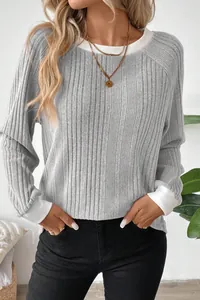 Detail view of stylish grey ribbed knit sweater showing contrast white collar and cuffs