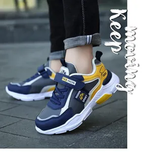 Close-up of stylish navy blue and yellow boys' sports shoes with Velcro strap