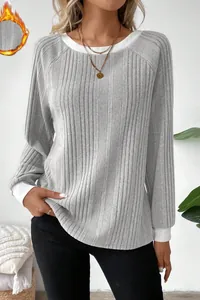 Detailed view of grey ribbed long sleeve sweater featuring white round neck and cuffs