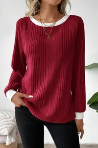 Detail of red ribbed long sleeve sweater with white contrasting collar and cuffs.