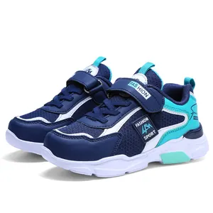 Detail view of boys' color-block running shoes in navy and teal with mesh upper.