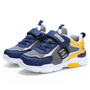 Detail view of boys' color-block running shoes with mesh upper and velcro strap