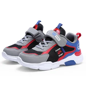 Detailed side view of boys' color-block sports sneakers featuring mesh and Velcro straps.