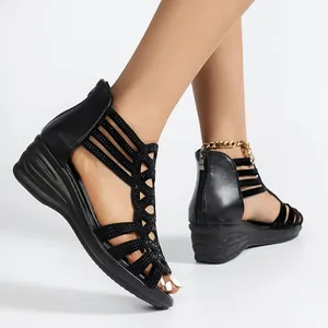 Detailed view of women's black Roman wedge sandals featuring hollow rhinestone-studded straps