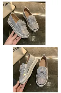 Détail rapproché des mocassins plateforme argentés à paillettes et nœud strass