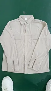 Detailed view of beige corduroy long-sleeved men's shirt with double chest pockets
