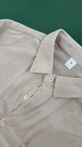 Close-up detail of a men's beige corduroy lapel shirt showing the fine fabric texture