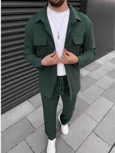 Men's dark green corduroy casual suit with long sleeve shirt and matching pants.