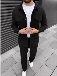 Men's stylish black corduroy long sleeve shirt and matching trousers casual outfit.
