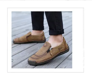 Close-up of men's casual brown leather loafers featuring side zipper and handmade stitching