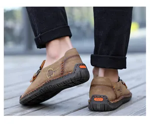 Close-up detail of brown men's casual leather loafers featuring zipper and handmade stitching
