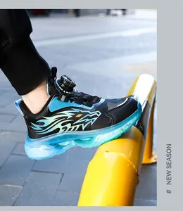 Detailed side view of boys' athletic shoes with rotary buckle and dragon flame design