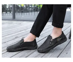 Detail view of black men's casual leather slip-on loafers with side zipper and stitching