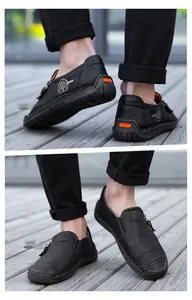 Detail shot of black leather slip-on loafers with stylish zipper and tree logo.