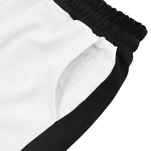 Detailed view of men's contrast sweatpants featuring elastic waistband and pocket