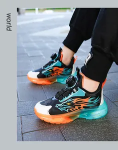 Close-up of boys' sports shoes with rotary buckle lacing and dragon flame pattern