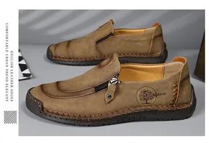Detailed view of handmade men's leather loafers with side zipper and tree logo