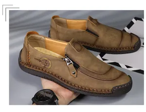 Detail of brown men's casual leather loafers with side zipper and hand-stitched sole.