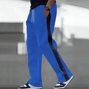 Close-up side view of men's blue straight-leg sweatpants featuring a black side stripe