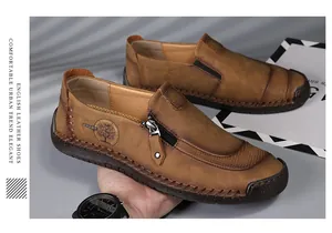 Close-up of brown men's casual leather shoes with decorative zipper and stitching