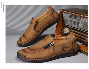 Classic men's vintage brown leather loafers featuring a side zipper and tree logo.