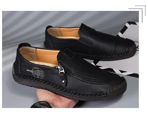 Close-up of black leather loafer with fashion zipper and handmade stitching details