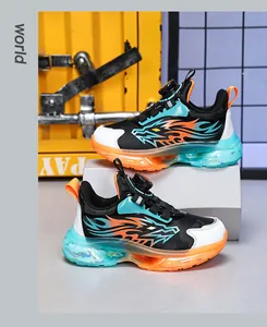 Detailed view of kids' athletic shoes featuring a flame pattern and rotating buckle system.